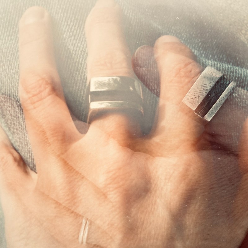 overlay of two photographs of people's hands looking like they are holding hands